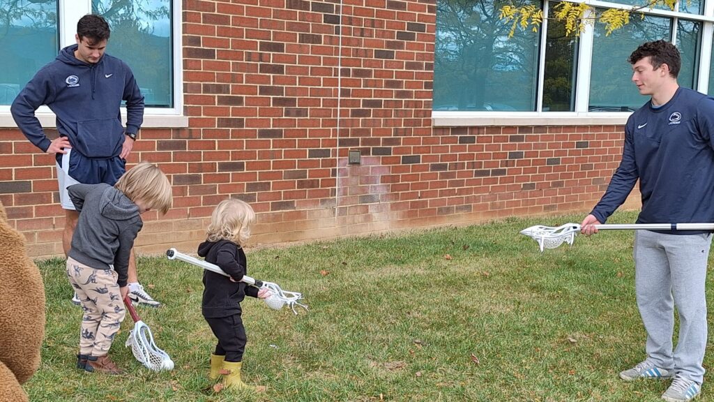 Penn State students teach young children about Lacrosse