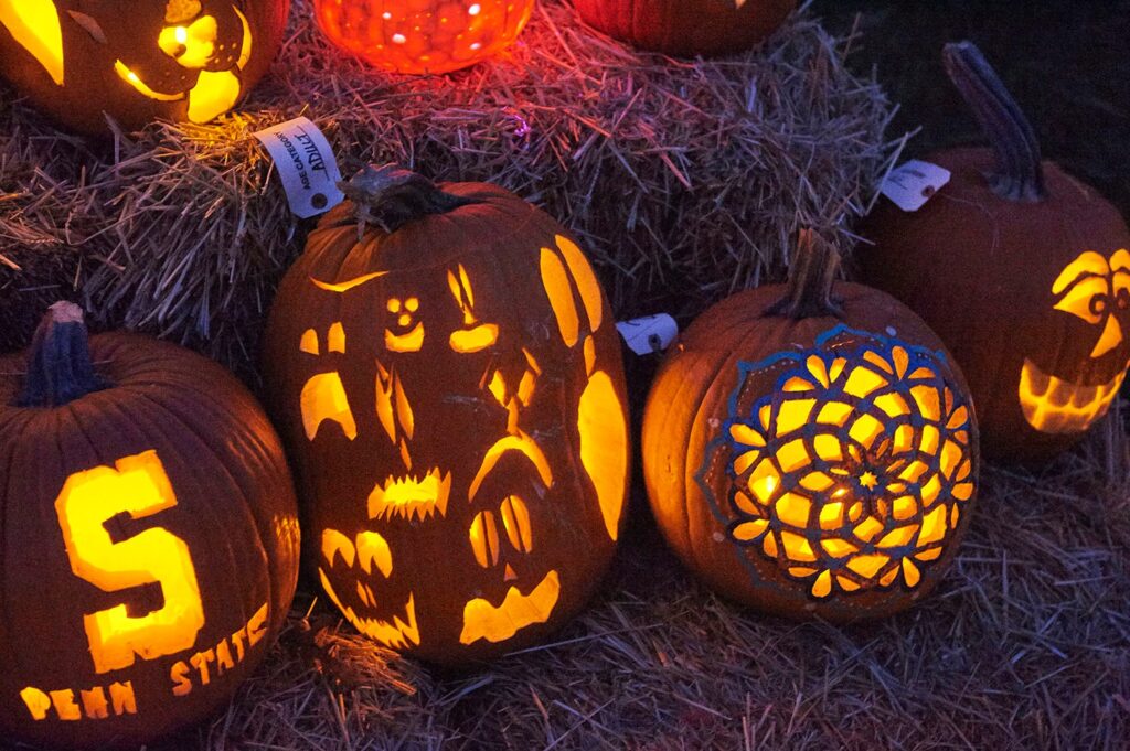 Carved pumpkins glowing in the dark