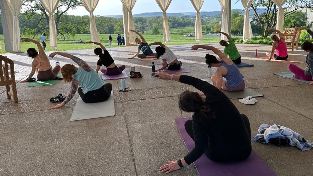 A group doing yoga at the Arboretum
