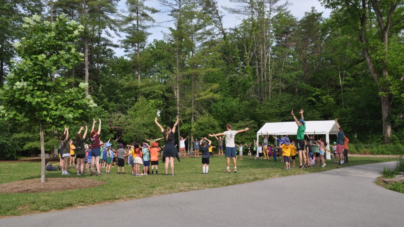 A group of campers at Shaver's Creek summer camp standing in a circle and participating in an activity.