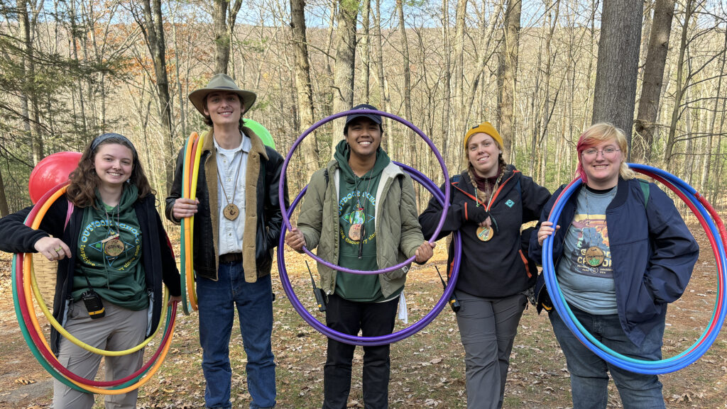 Students in the woods at Shaver's Creek with hula hoops.