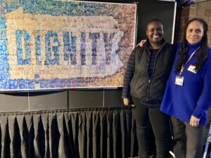 Attendees in front of the Dignity Day mosaic.