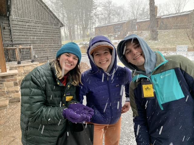 Celia Graef (center) enduring the weather with friends at Shaver's Creek.