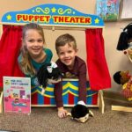 Kids playing in a puppet theater